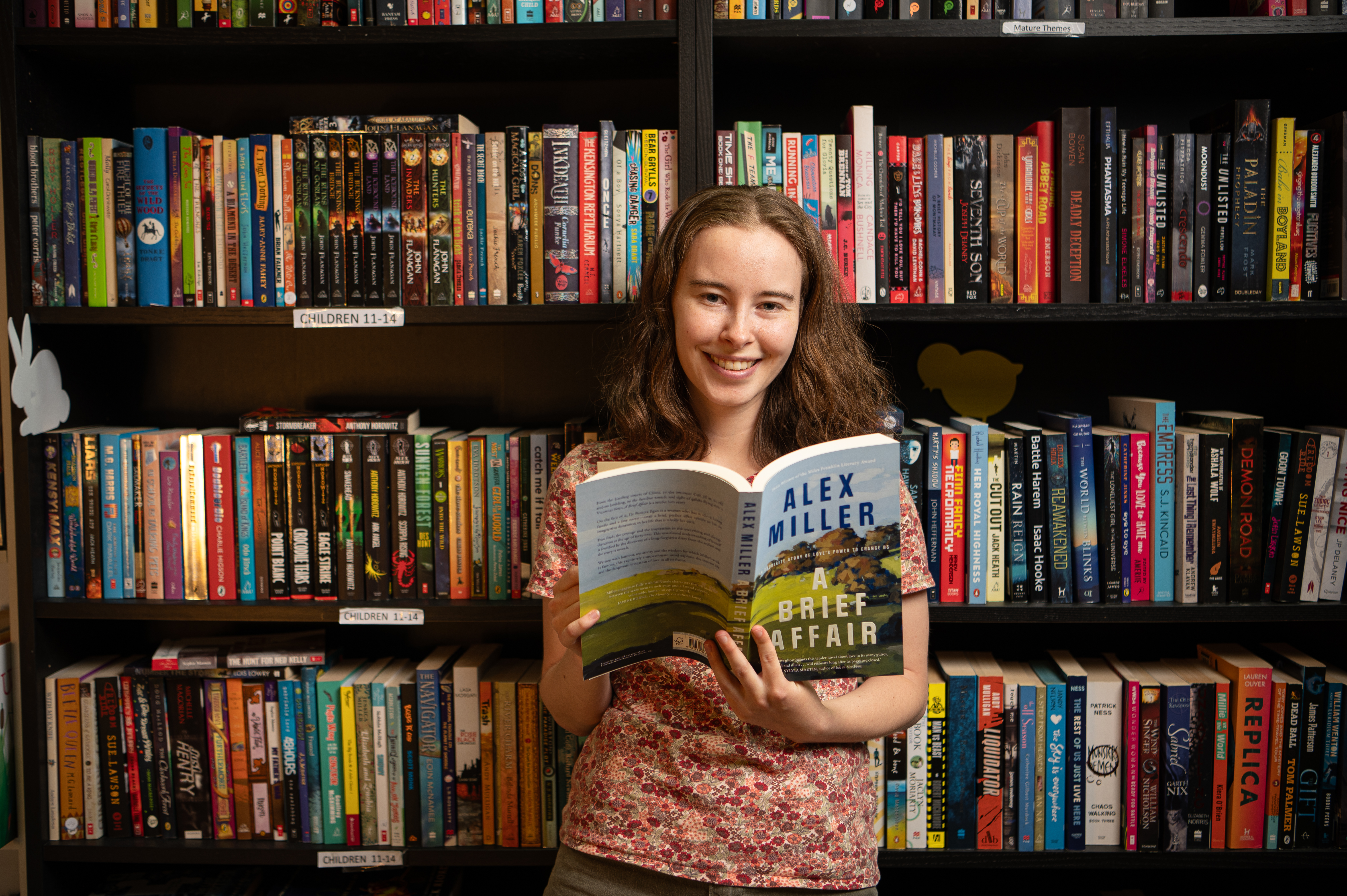 Woman smiling reading book